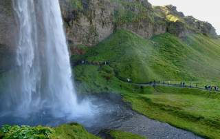 Seljalandsfoss Tourists Walk Behind Waterfall, Iceland South Coast Day Trip